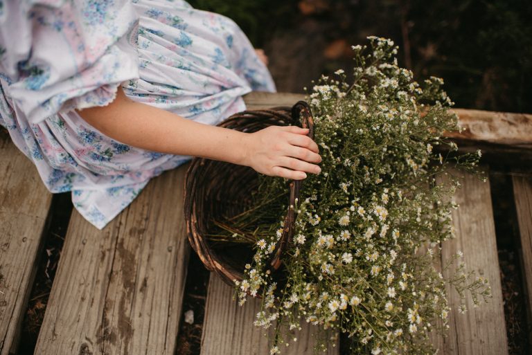 Woman in Selkie La Belle Etoile French Puff Dress running in field next to cottagecore barn